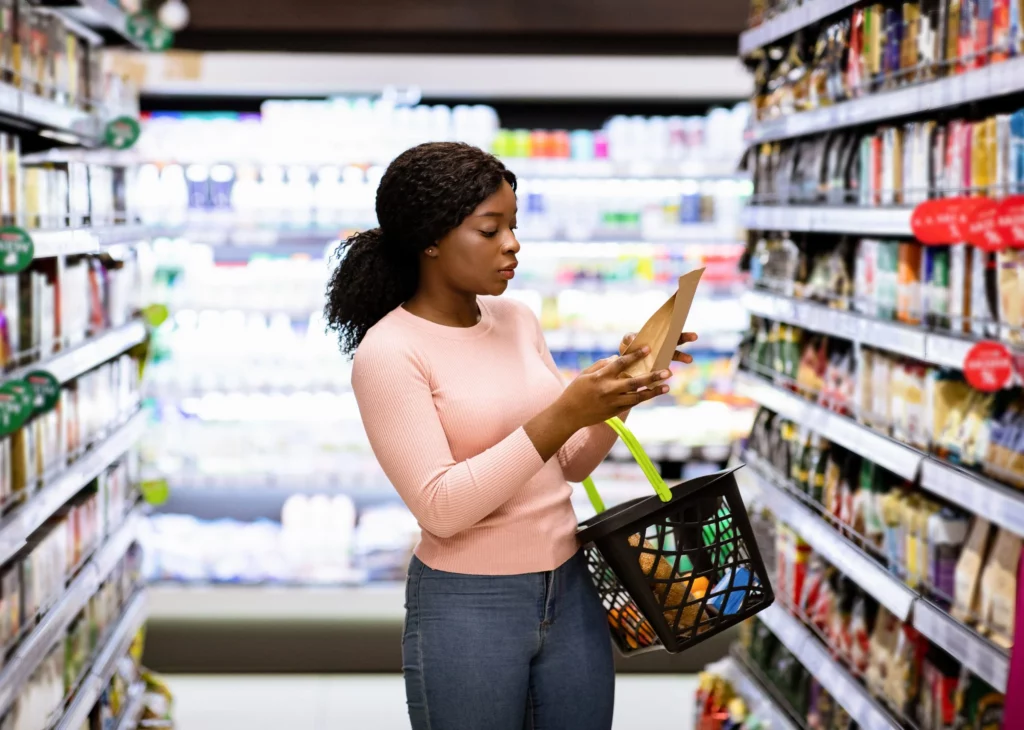 Shopper looking at food and packaging design in a retail grocery store.